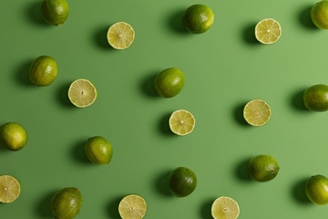 Evergreen edible tropical citrus limes provides juice or peel to food dishes for refreshing, tart flavor. Fruit used in baked goods and desserts, popular alcoholic beverages. Nobody on photo