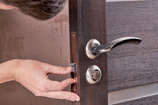 person fixing door furniture. improvement process.