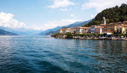 Fototapeta na wymiar Beautiful coastline with old town by the Maggiore lake. Italy. Wonderful view on popular historical tourist resort town Cannero Riviera on Lago Maggiore lake, Alps mountains, Italy