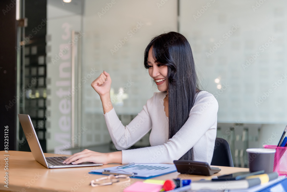 Wall mural young, happy, cheerful, bright, cute, beautiful business women with a smile on the phone, sitting in