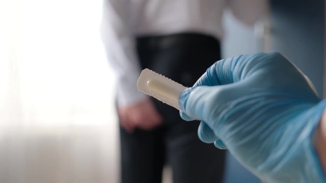 Hemorrhoids and other diseases of the rectum. Doctor showing suppository for hemorrhoids, closeup