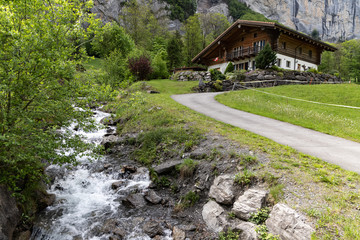 Fototapeta na wymiar A House at a river in Lauterbrunnen Landscape