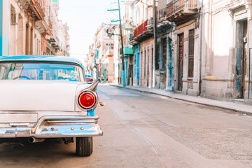 Naklejka na ściany i meble View of yellow classic vintage car in Old Havana, Cuba