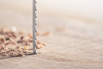 Fret saw cutting wooden oak plank. Jig saw cut clean timber plank.