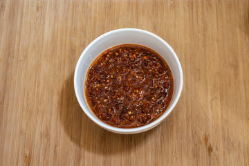Red pesto sauce on a wooden table.