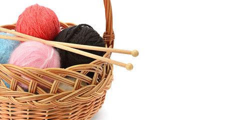 Wool balls in a basket isolated on a white background. Free space for text. Wide photo .