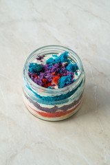 Rainbow Cake Dessert in Glass Jar Flavored with Dragee and Fruits.