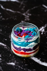 Rainbow Cake Dessert in Glass Jar Flavored with Dragee and Fruits.