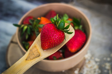 Breakfast strawberries on a wooden spoon