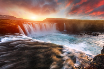 Godafoss waterfall with dramatic colorful sky during sunset, Icelandic nature scenery Amazing long...