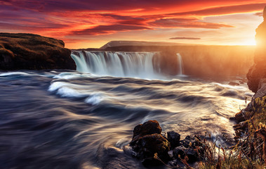 Scenic image of Iceland at sunset. Godafoss, One of the most famous waterfalls in Iceland. Amazing nature scenery. Iconic location for landscape photographers. Travel concept. Artistic Creative image.