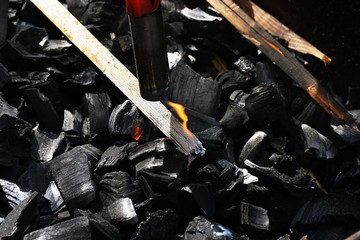 Kindle coal with a gas cylinder for cooking kebabs