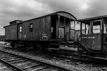 Fototapeta na wymiar Old vintage wagon on the tracks, monochrome image