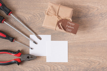 Top view of a greeting card with the handwritten inscription happy father's day, hammer, pliers,...