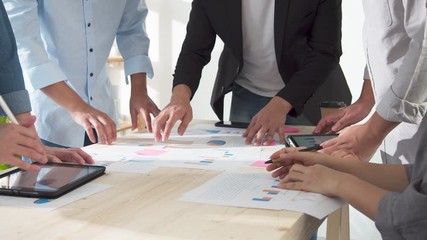 Close up Hands of asian creative employee standing and brainstorming stategy plan in happy workshop at creative workplace. Effective meeting, productive workshop and synergy business concept