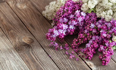 Background of lilac blooming on a wooden background.