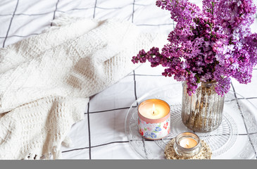 Cozy home interior with a bouquet of lilac.