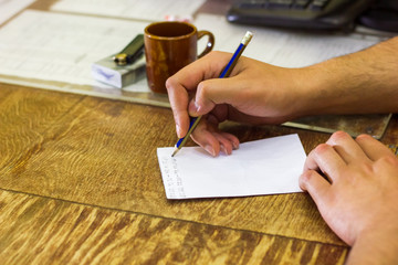 Fototapeta na wymiar hand writing on a paper, hand with pen and paper, writing hand on a paper with pencil