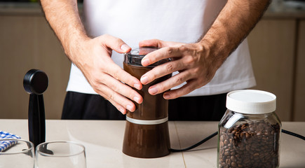 Man grinding coffee beans for espresso