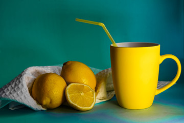 Yellow mug with lemonade and lemons on a blue background