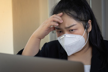 Young business woman working from home wearing protective mask.Working from home.quarantine for coronavirus