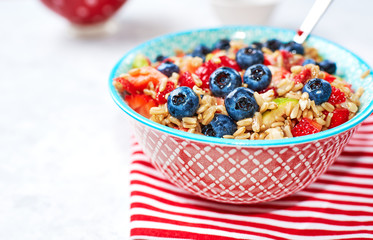Healthy Homemade Oatmeal with strawberries, blueberries for Breakfast