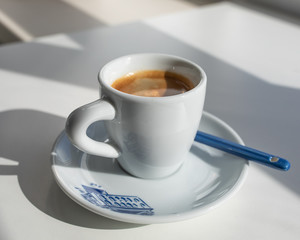 Espresso in a white cup with a blue print