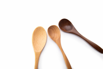 empty Spoons of different sizes and color.Three wooden spoons  isolated on white background. 