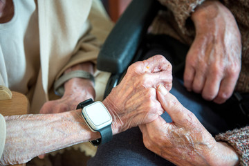 Elderly couple with alzheimer's and dementia holding hands and showing affection towards one...