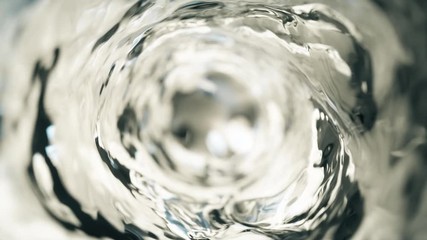 Water moves in a glass in slow motion - Powered by Adobe