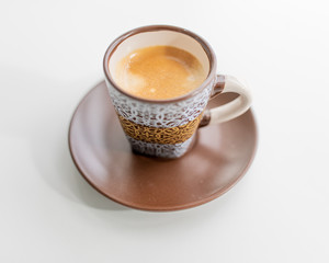 Espresso in a brown cup with a white print