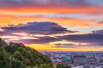 Fototapeta premium Beautiful clouds at sunset over Kyiv city with view from the Pedestrian Bridge.