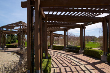Fototapeta na wymiar The wooden canopy made of beams - pergola in the patio of the public park in Richmond Hill, Ontario, Canada.