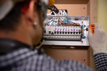 Close-Up Of Electrician Work.Electrician engineer tests electrical installations and wires on relay...