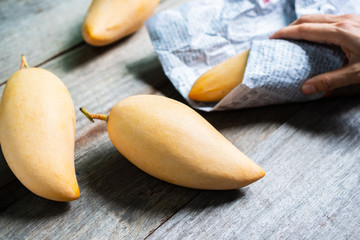 Barracuda mangoes on wooden table. Sweet and delicious Thai fruit. Close up