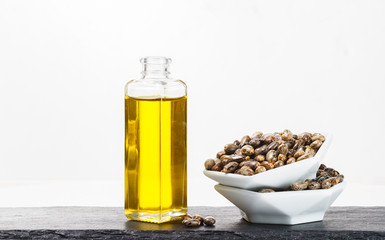 castor oil and seeds isolated on white background, close-up image