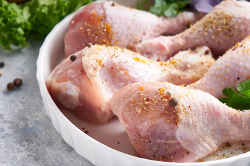 Uncooked chicken drumstick with spices and turmeric