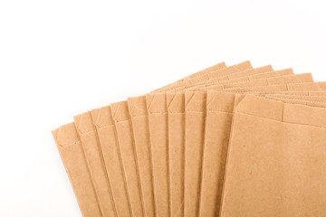 New brown craft paper bags fan-shaped on a white background. Packaging for goods, food, letters.