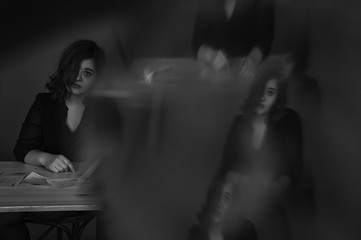 a girl through a prism, a girl of Georgian appearance cries at a table, a girl with curly hair pours tears on her cheek, sits sadly at a table