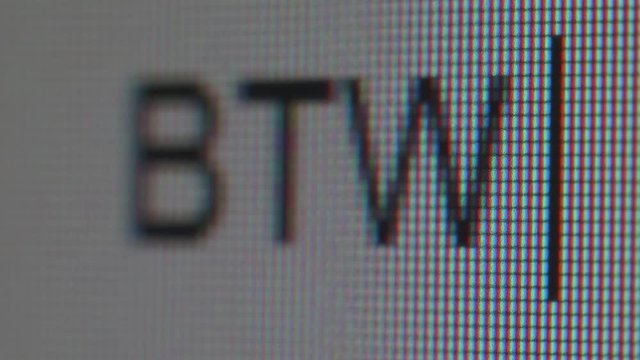 Texting of abbreviation of word between. Close up view.