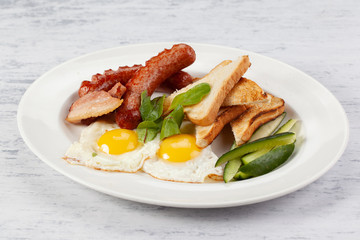 Sausages with  fried eggs,  bacon and toast