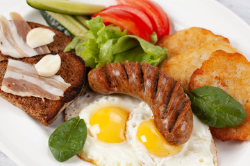 Hearty breakfast. Potato pancakes with sausage, fried egg