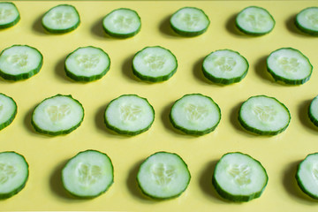 cucumber slices are placed on a colored glass table
