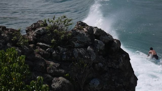 Man doing a few turns on a wave throwing nice sprays, 