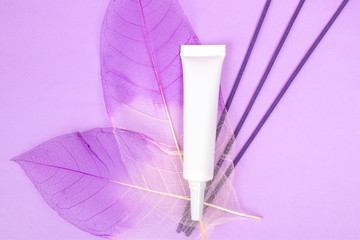 Cosmetic tube mock up isolated on lilac background. Lotion skin care bottle template. Beauty concept. Cream packaging stand mockup.