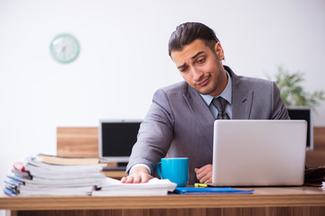 Young male employee unhappy with excessive work