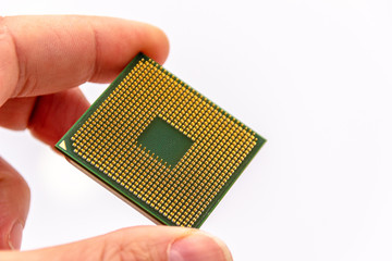 Microprocessor in hand. Golden pins facing up. The concept of new technologies