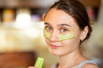 a pretty young girl with facial cucumber mask