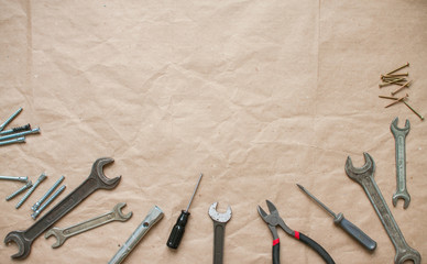 The layout of the tools on the craft background. Pliers, screwdriver, wrenches. Male background. Banner