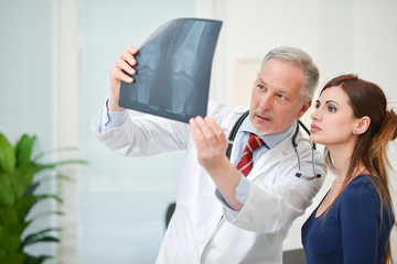 Doctor showing a radiography to his patient